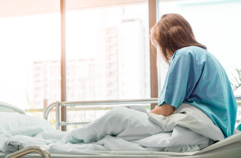 injured woman sitting in hospital bed